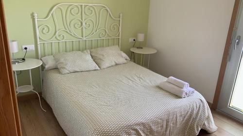 a bedroom with a white bed and two night stands at Apartamentos en la playa in Villanueva