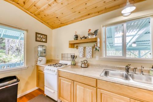a kitchen with a sink and a stove at Kahu 'lo - Guardian Hawk in Volcano