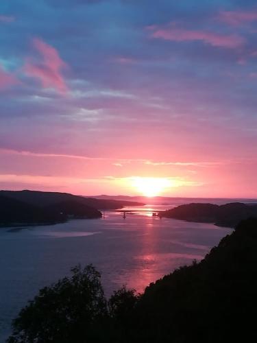 a sunset over a large body of water at Norway Stabben Tour in Tustna