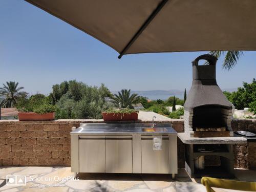 a outdoor kitchen with a stove and a grill at Out of Africa Resort in Had Nes