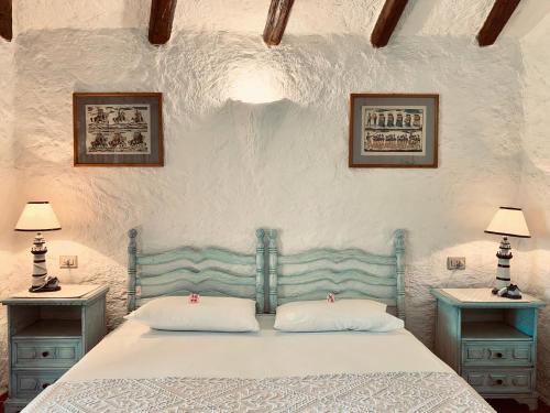 a bedroom with a bed with two night stands and two lamps at Eleni Room in Costa Dorata