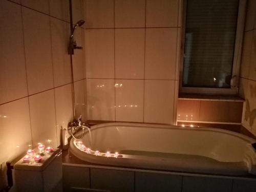 a bathroom with a tub with christmas lights around it at Pensiunea Pont-Euxin in Constanţa
