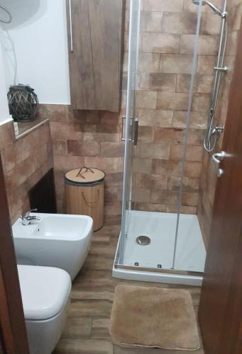 a bathroom with a shower and a toilet and a sink at Bed and breakfast Raggio di Sole in Iglesias