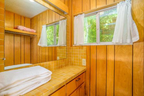 a bathroom with a shower and a sink and a window at Grandma's Sandbox in Beulah