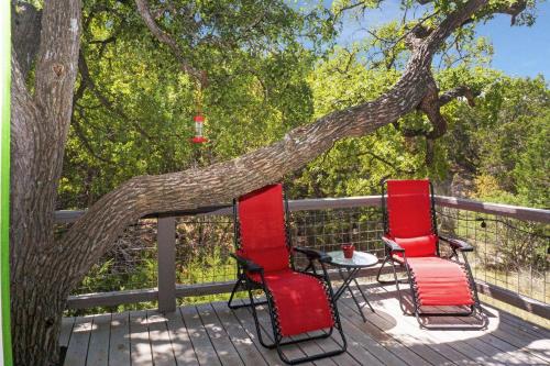three chairs and a table on a deck with a tree at Arbor House of Dripping Springs - Garden House in Dripping Springs