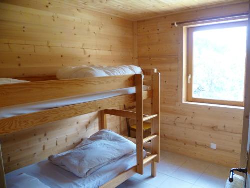 a log cabin with two bunk beds in it at Appartement de 3 chambres avec jardin amenage et wifi a Notre Dame de Bellecombe a 1 km des pistes in Notre-Dame-de-Bellecombe