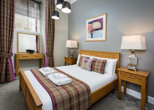 a bedroom with a bed with two towels on it at Old Town Suites - Nicolson in Edinburgh