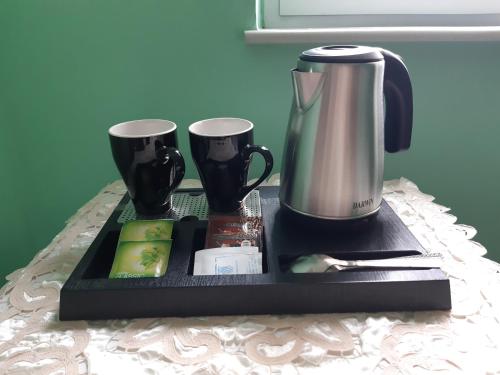 a tray with a coffee maker and cups on a table at Christina Guest House in Mystras