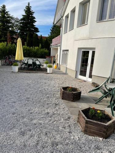 a patio with two baskets of flowers and a building at Villa Astoria in Balatongyörök