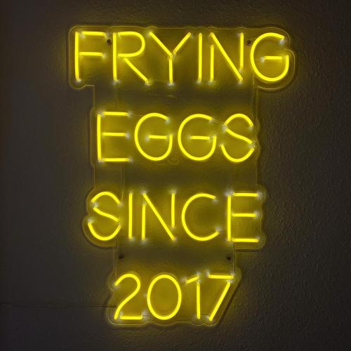 a neon sign that says flying eggs since at Crafnant House - Bed & Breakfast in Trefriw