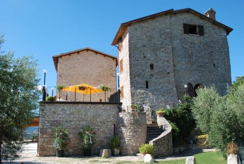 a building with a table and an umbrella on it at Il Castello Di Perchia in Crocemaroggia