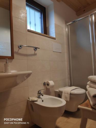 a bathroom with a sink and a toilet and a shower at Le Corti del Casale in Alberobello