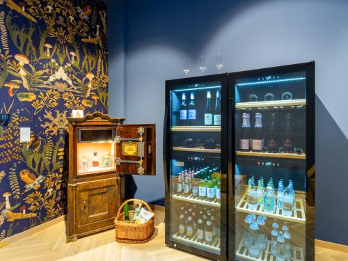 a room with a refrigerator filled with lots of bottles at Das Schider - Boutique Apart-Hotel in Bad Gastein