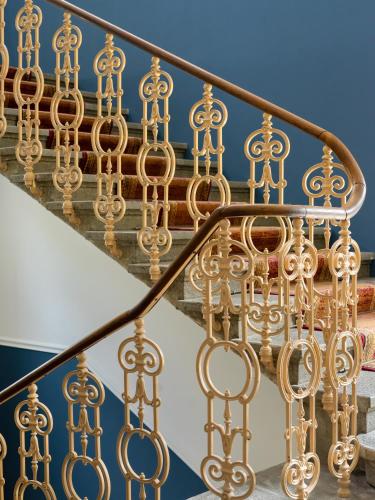 a close up of a gold railing on a staircase at Das Schider - Boutique Apart-Hotel in Bad Gastein