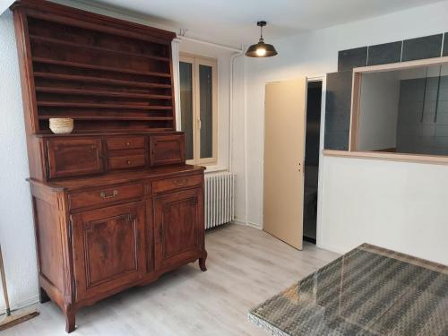 a room with a large wooden dresser in a room at Château de Passières in Chichilianne