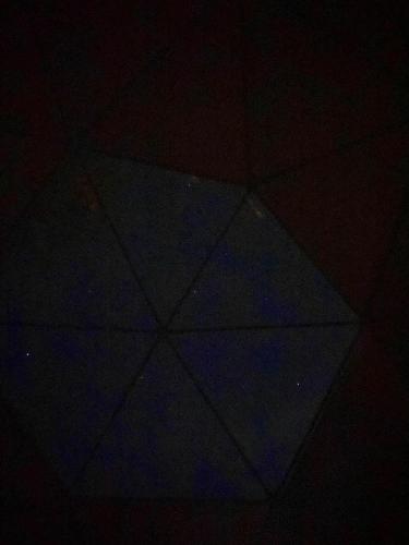 a blue kite is lit up in the dark at COSMOS GLAMPING ARTEAGA in Arteaga