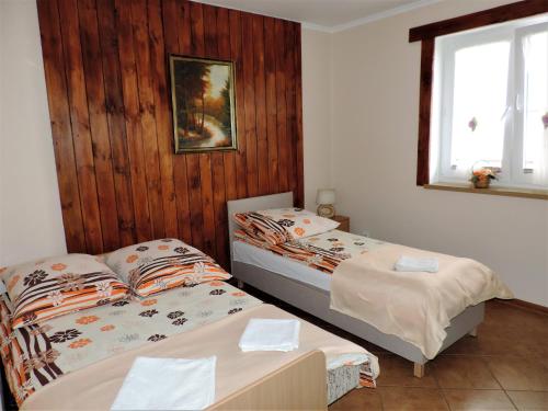 a bedroom with two beds and a window at Jacek i Agatka in Ustka