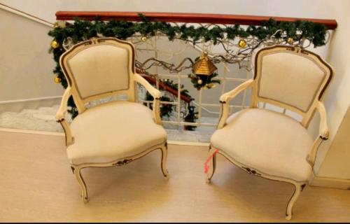 two chairs sitting next to each other in a room at hotel lisà in Viareggio