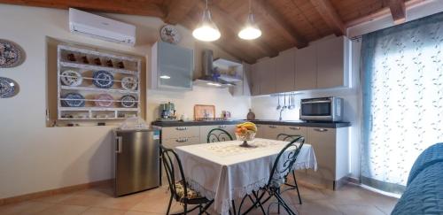 a kitchen with a table and chairs and a kitchen with a table and a table at Comfortable apartment in Capitana 50 sqm, sea view, garden in Capitana