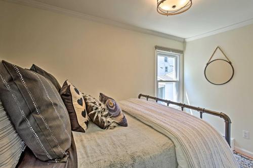 a bedroom with a bed with pillows and a mirror at Updated Home with Patio Half Mile to West Point in Highland Falls