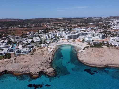 an aerial view of a beach with buildings and the ocean at Anonymous Beach Hotel (Adults 16+) in Ayia Napa