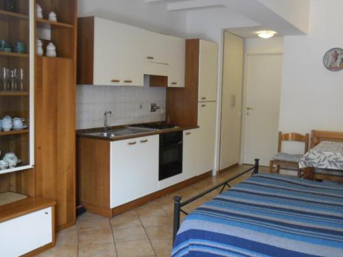 a room with a kitchen and a bed in it at Appartamenti Claudia Rio in Rio Marina