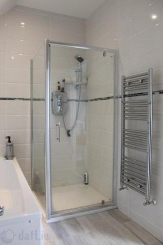 a shower with a glass door in a bathroom at The Grove in Belturbet
