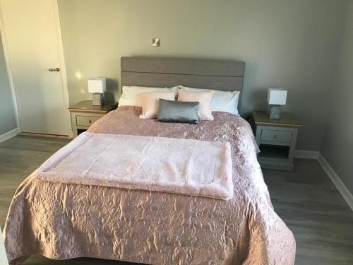 a bedroom with a large bed with two night stands at The Grove in Belturbet
