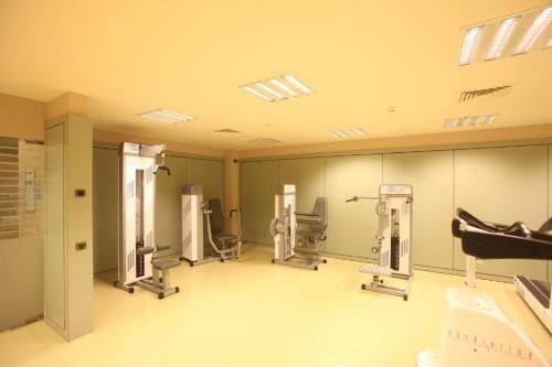 a gym with several treadmills and machines at Hotel Nordic in El Tarter