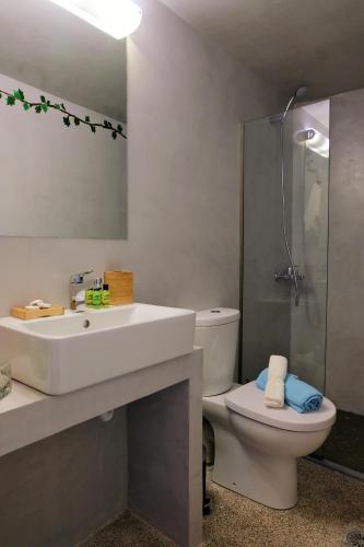 a bathroom with a sink and a toilet and a shower at REMVI Apartments Assos in Asos