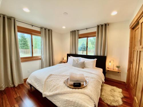 a bedroom with a large bed with a tray on it at The Cascade Chalet - Leavenworth in Leavenworth