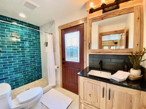a bathroom with a toilet and a sink and a mirror at The Cascade Chalet - Leavenworth in Leavenworth