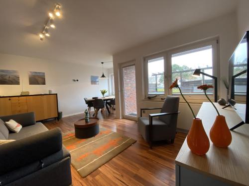 a living room with a couch and a table at Ferienwohnung Dünengraf in Wangerooge