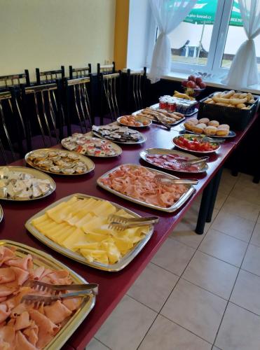 a long table filled with different types of food at Hotel U Jezírka in Liberec