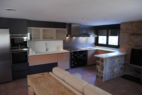 a living room with a couch and a kitchen at Villa Adilia 