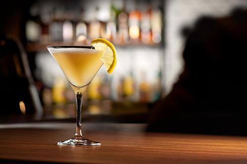 a martini glass with a lemon slice on a table at Holiday Inn Yerevan - Republic Square by IHG in Yerevan