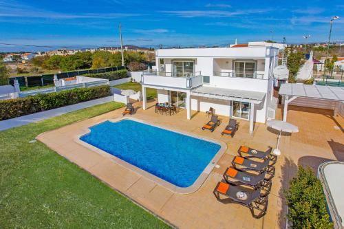 an aerial view of a house with a swimming pool at Villa Pianda by Villa Plus in Almancil