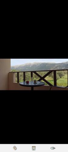 a table on a balcony with a view of a field at Xenonas Anopolis 2 in Anopoli Sfakion