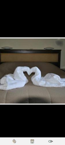 a pair of towels forming a heart on a bed at Xenonas Anopolis 2 in Anopoli Sfakion