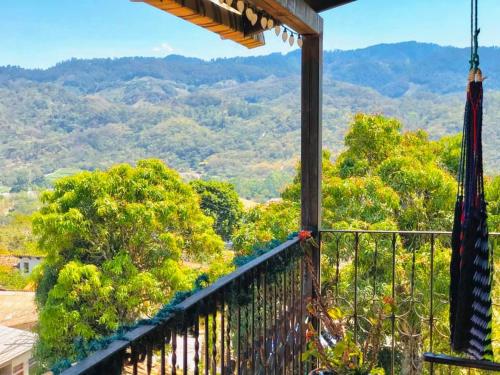 a balcony with a view of trees and mountains at HOTEL EL ALMENDRO in Copan Ruinas