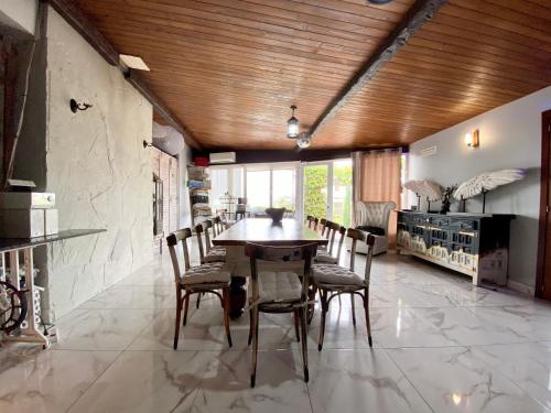 a dining room with a wooden ceiling and a table and chairs at Boutique home the beach in Malgrat de Mar