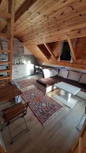 a living room with a couch and a rug at Apartments Durmitor in Žabljak