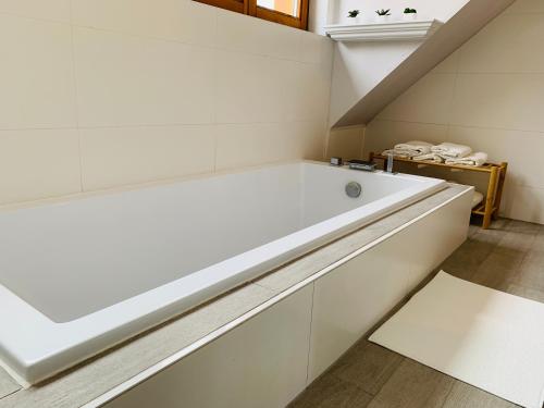 a large white bath tub in a bathroom at Ferienwohnung Heidi in Leutschach