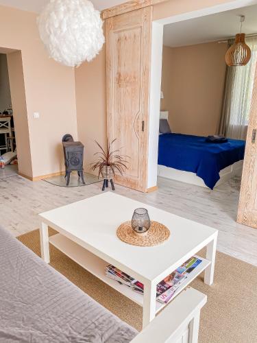 a living room with a white coffee table and a bed at Kolka in Kolka
