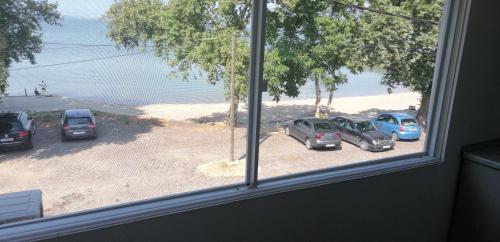 a view of cars parked in a parking lot from a window at Apartment Chukov in Star Dojran