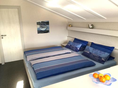 a bedroom with a bed with blue pillows at Appartement im Himmelreich in Lam