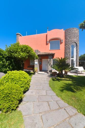 a house with a stone pathway in front of it at Villa Stefania in Ischia