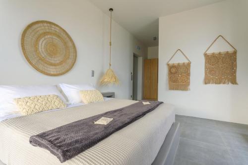 a bedroom with a bed with a blanket on it at Iliades Luxury Boutique Suites in Batsi