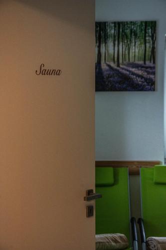 a door in a room with a picture on the wall at Hiša Bohinc z wellnessom in Tolmin