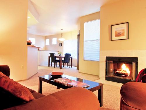 a living room with a couch and a fireplace at Raintree at Phoenix South Mountain Preserve in Phoenix